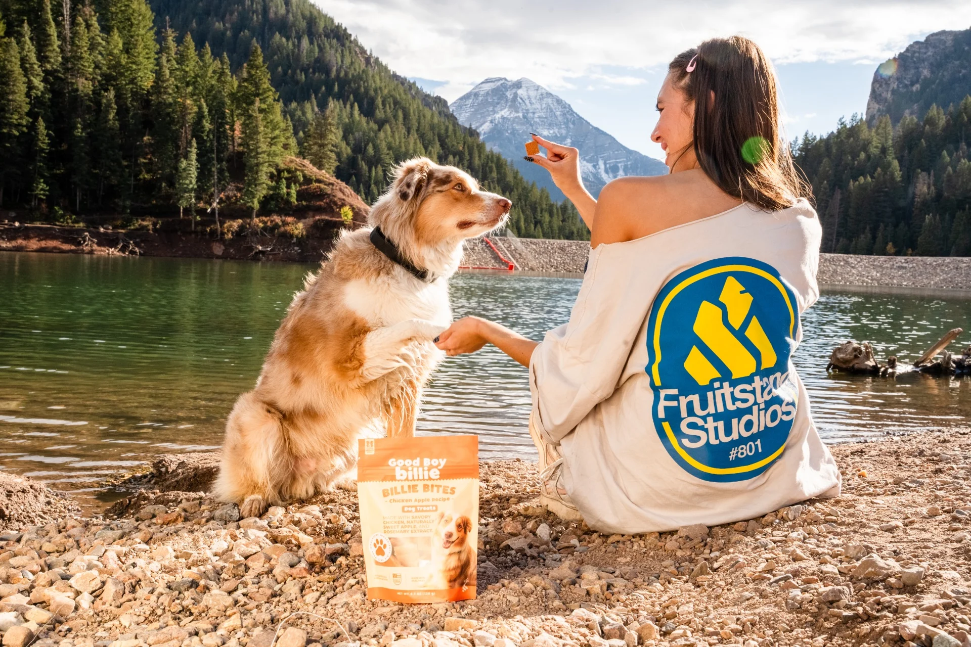 Billie enjoying a treat beside a mountain lake